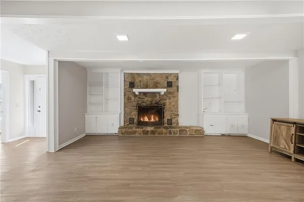 wooden floor fireplace and natural light in room
