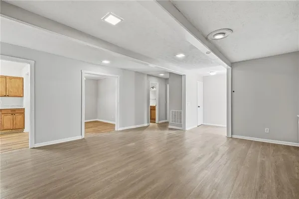 a view of an empty room with wooden floor
