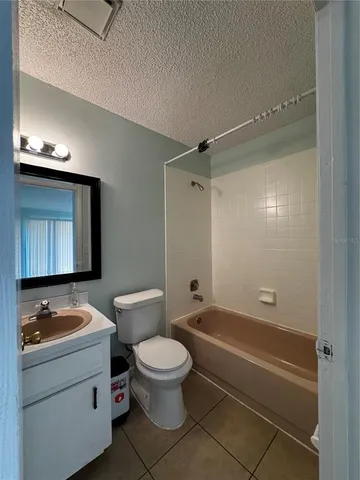 a bathroom with a toilet a sink and bathtub