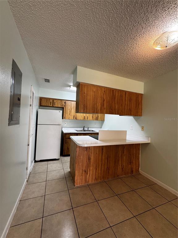 1755 Southwest 108th Lane, Unit 2 Ocala, FL 34476 - Photo 5 of 16 a kitchen with a sink a refrigerator and a stove