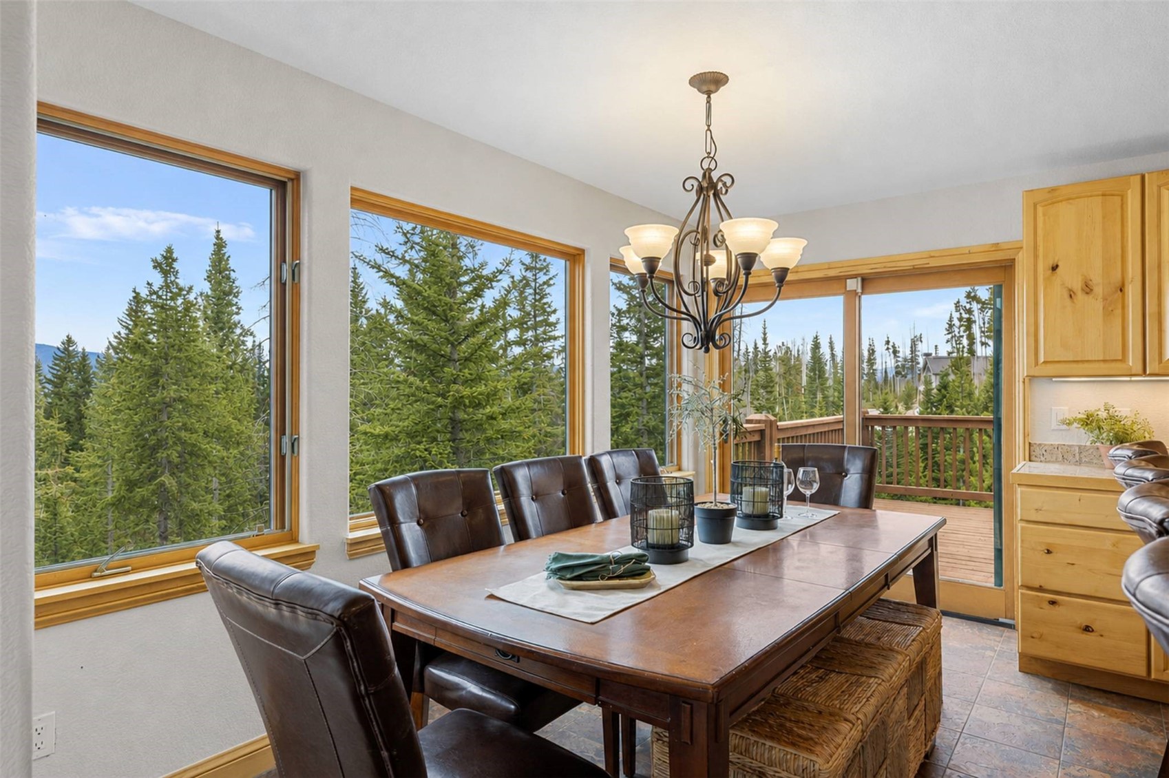 91795 Ryan Gulch Road Silverthorne, CO 80498 - Photo 2 of 50 a view of a dining room with furniture large windows and a chandelier