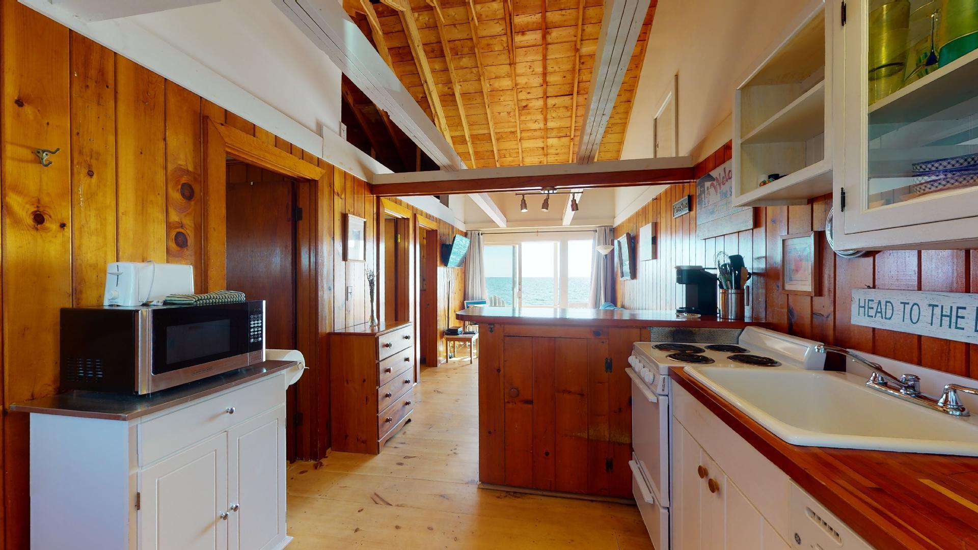 314 Shore Road, Unit 4 5 Truro, MA 02666 - Photo 11 of 50 a kitchen with stainless steel appliances granite countertop a sink a stove and a refrigerator