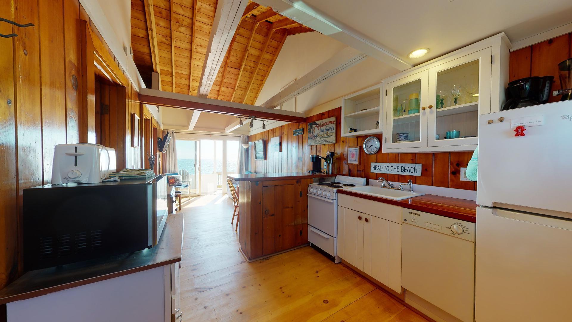 314 Shore Road, Unit 4 5 Truro, MA 02666 - Photo 12 of 50 a kitchen with stainless steel appliances a stove and a refrigerator