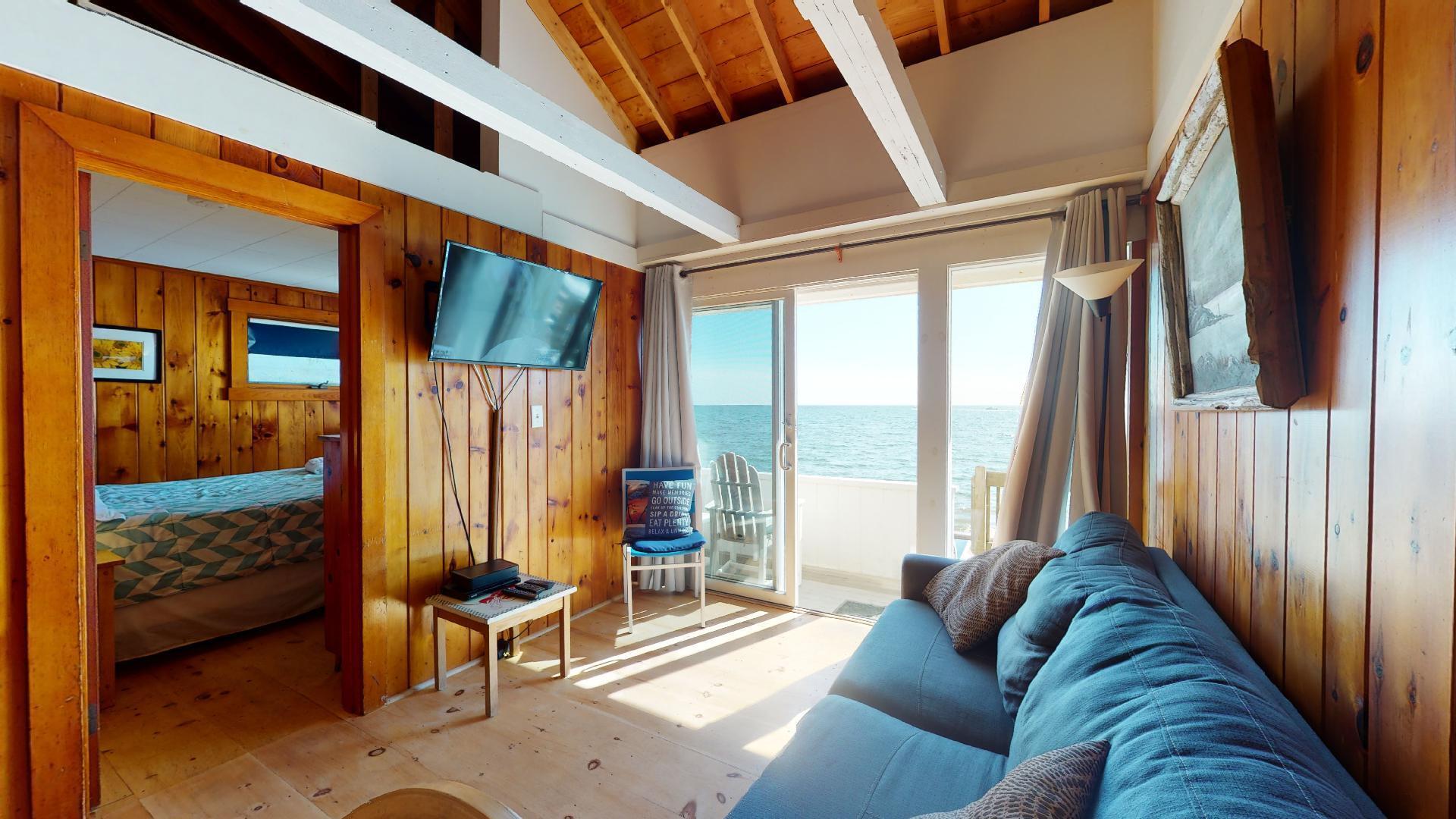 314 Shore Road, Unit 4 5 Truro, MA 02666 - Photo 14 of 50 a living room with furniture and a floor to ceiling window