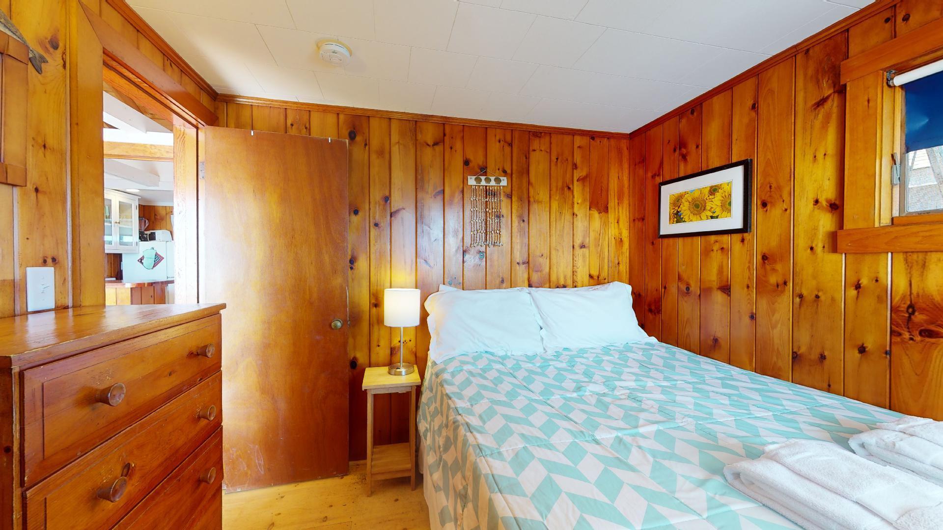 314 Shore Road, Unit 4 5 Truro, MA 02666 - Photo 20 of 50 a bedroom with a bed and wooden floor