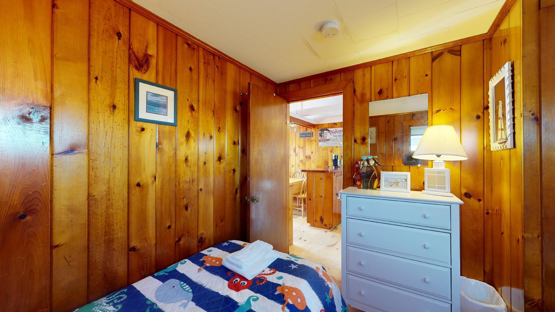 314 Shore Road, Unit 4 5 Truro, MA 02666 - Photo 25 of 50 a bedroom with a bed and a dresser