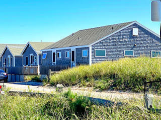 314 Shore Road, Unit 4 5 Truro, MA 02666 - Photo 3 of 50 a front view of a house with a yard and potted plants