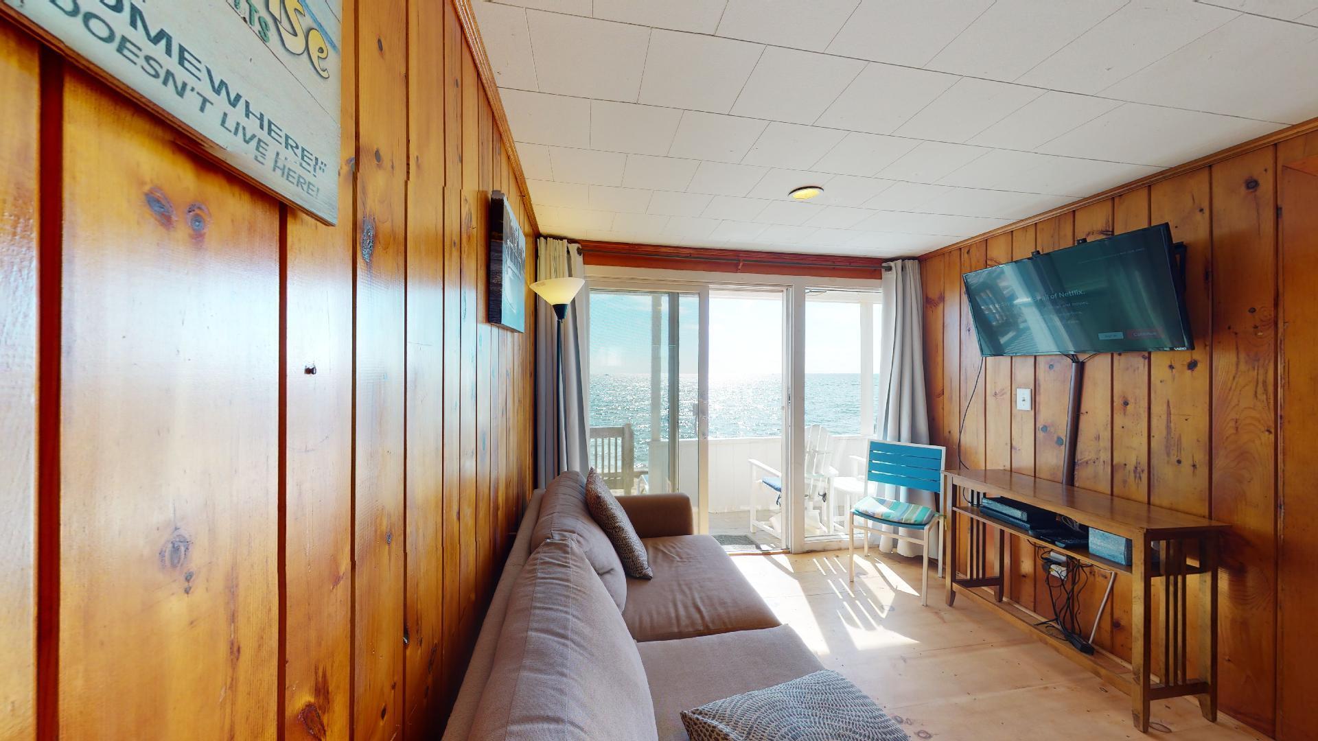 314 Shore Road, Unit 4 5 Truro, MA 02666 - Photo 34 of 50 a living room with furniture a flat screen tv and a window