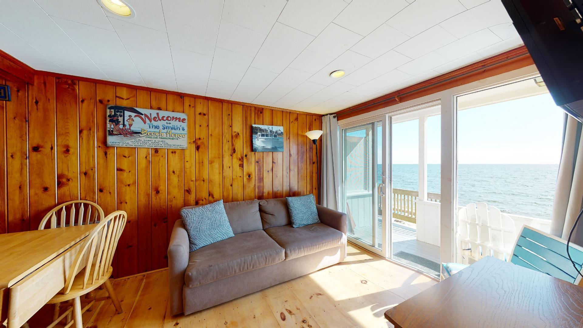 314 Shore Road, Unit 4 5 Truro, MA 02666 - Photo 36 of 50 a living room with furniture and a floor to ceiling window
