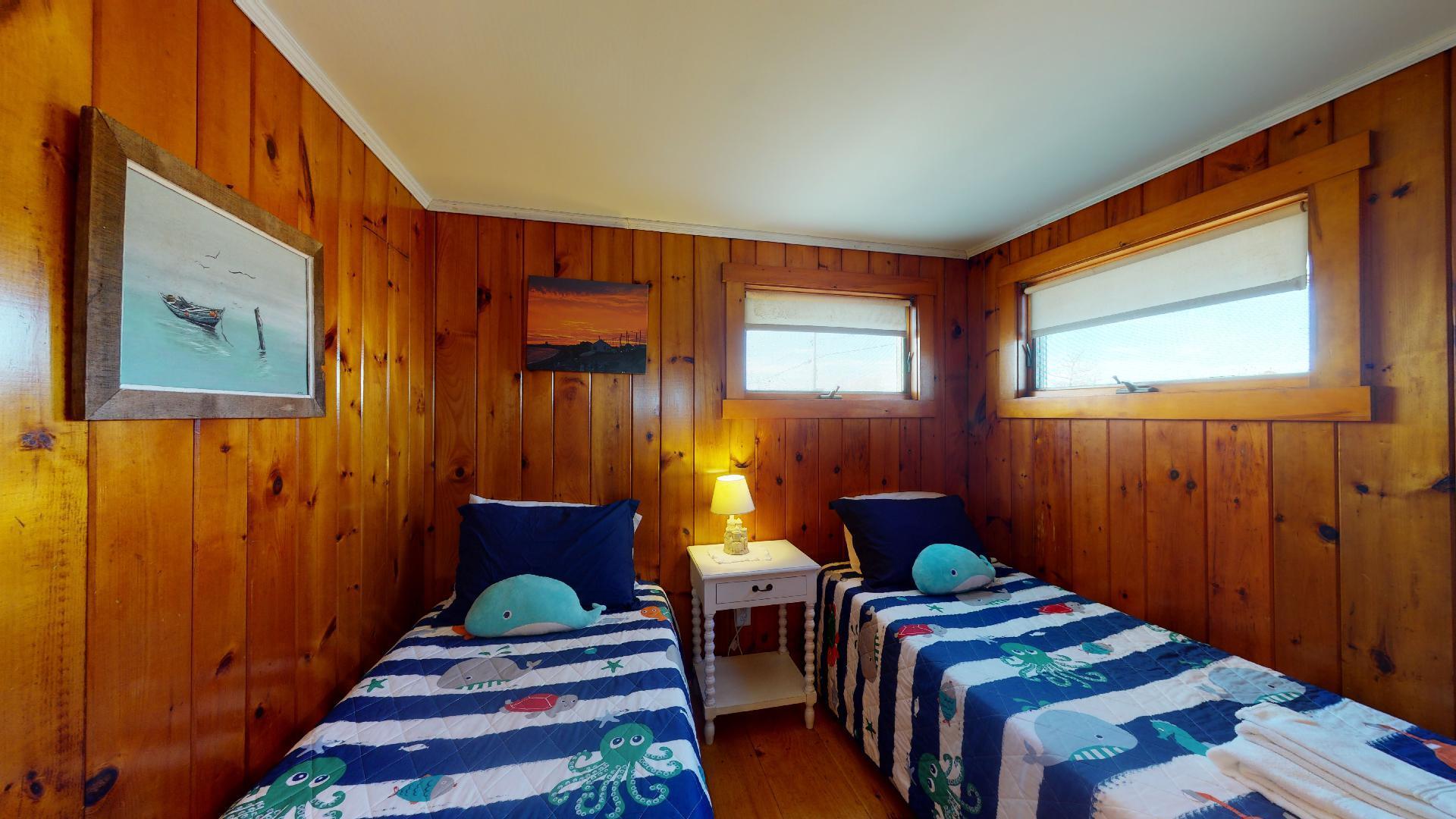 314 Shore Road, Unit 4 5 Truro, MA 02666 - Photo 41 of 50 a bedroom with a bed and wooden floor