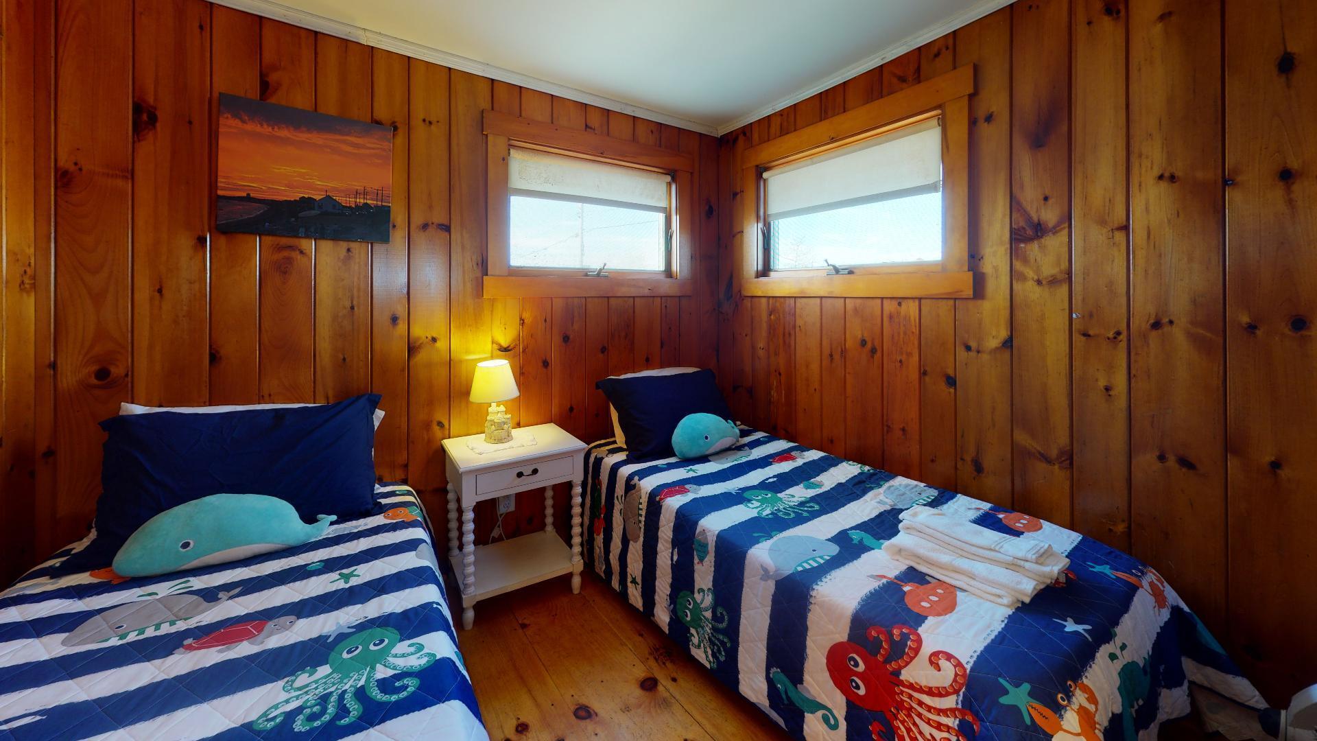 314 Shore Road, Unit 4 5 Truro, MA 02666 - Photo 42 of 50 a bedroom with two beds and a window