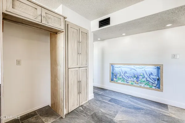 a view of an empty room with painting on the wall