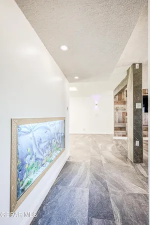 a view of an empty room with a painting on the wall