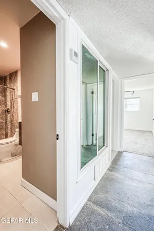 a view of a bathroom that has a glass door and a window