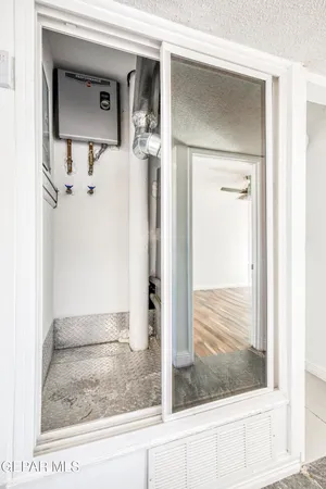 a view of a hallway with closet and windows