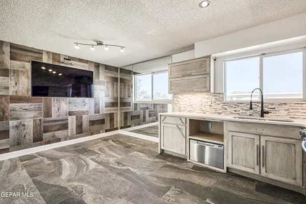 a kitchen with stainless steel appliances kitchen island granite countertop a stove and cabinets