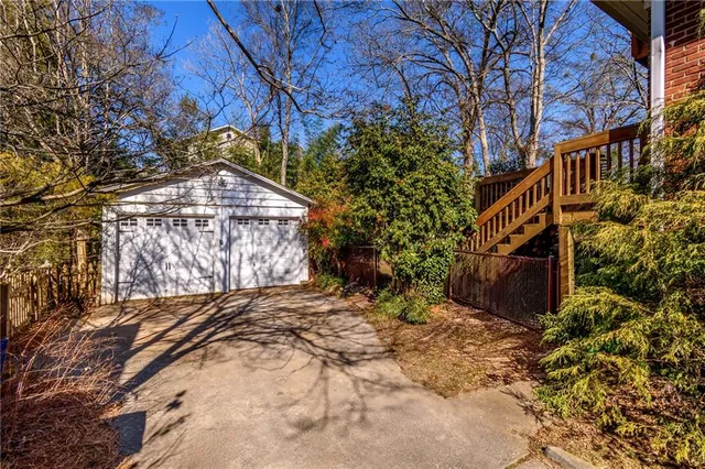 a view of a house with wooden fence and porch