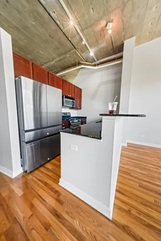 a kitchen with stainless steel appliances a refrigerator and a stove top oven