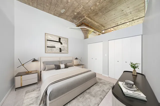 a bedroom with a bed and couch