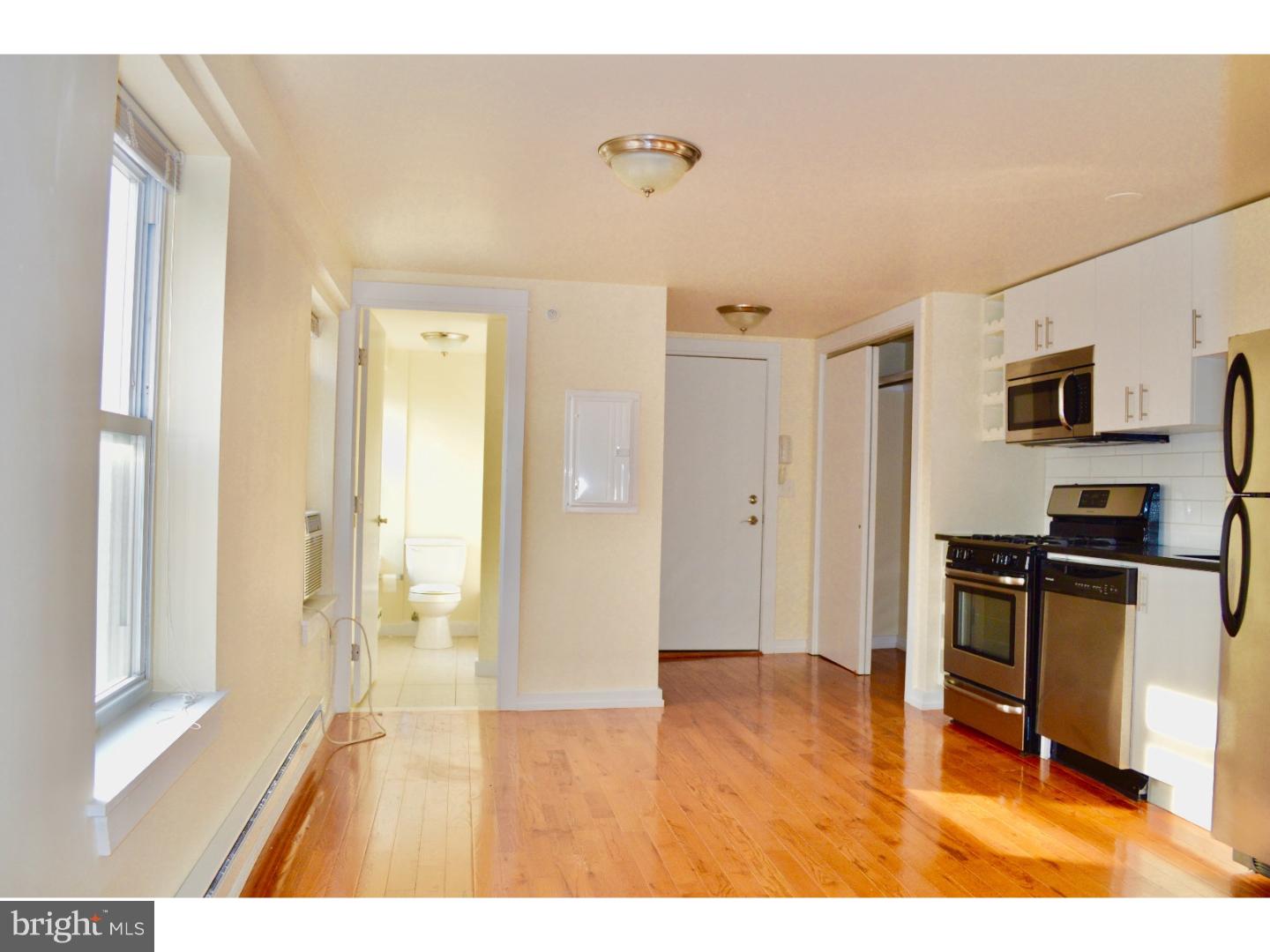 415 South Broad Street, Unit 3F Philadelphia, PA 19147 - Photo 10 of 13 a view of a livingroom with furniture a ceiling fan and wooden floor