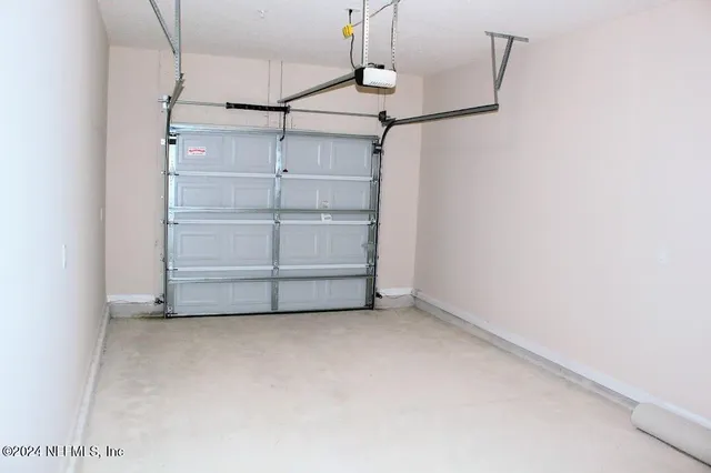 a view of a house with a large window and brick walls