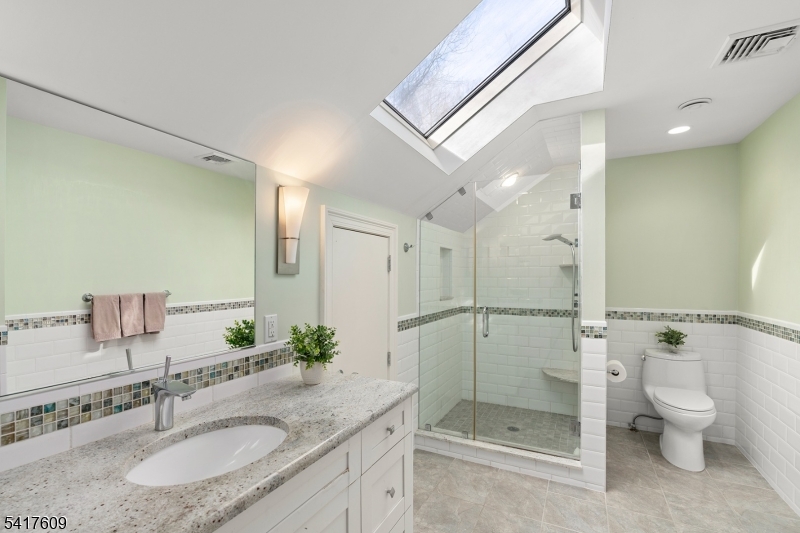 2 Cobblefield Road Mendham, NJ 07945 - Photo 30 of 50 a bathroom with a granite countertop sink a toilet and shower