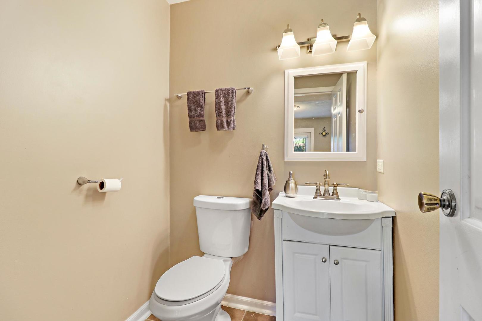 10254 West Beach Road Beach Park, IL 60099 - Photo 13 of 25 a bathroom with a toilet a sink and mirror