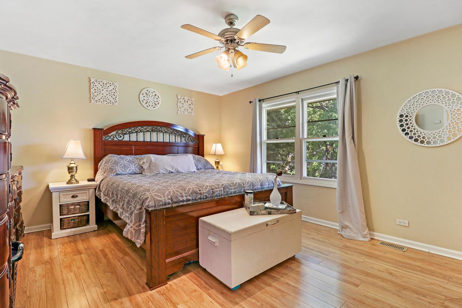 10254 West Beach Road Beach Park, IL 60099 - Photo 14 of 25 a bedroom with a bed and a chandelier