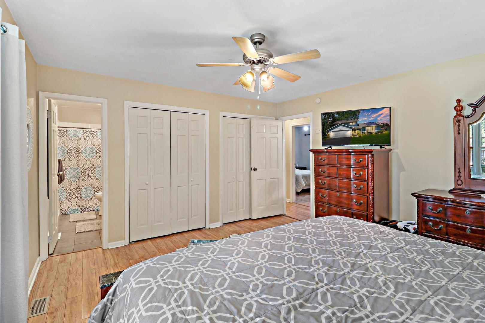 10254 West Beach Road Beach Park, IL 60099 - Photo 15 of 25 a bedroom with a bed and a flat tv screen on dresser
