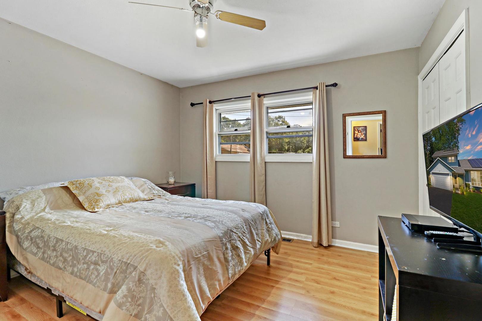10254 West Beach Road Beach Park, IL 60099 - Photo 19 of 25 a bedroom with a bed and a flat screen tv