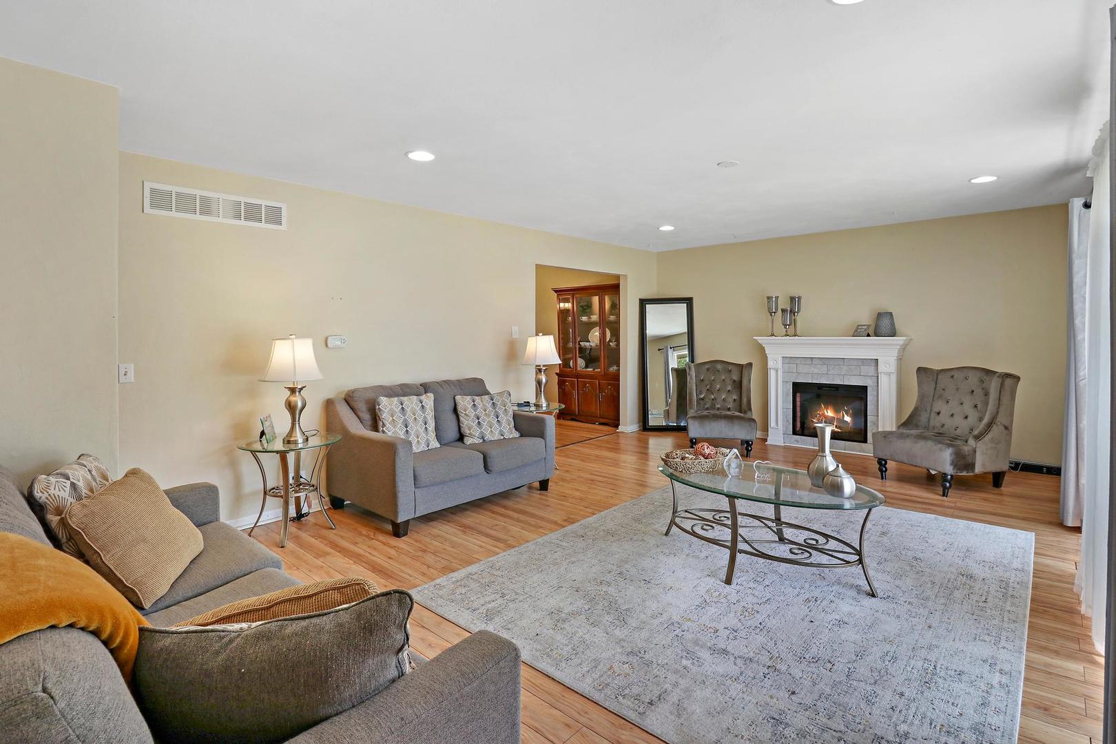 10254 West Beach Road Beach Park, IL 60099 - Photo 3 of 25 a living room with furniture and a fireplace