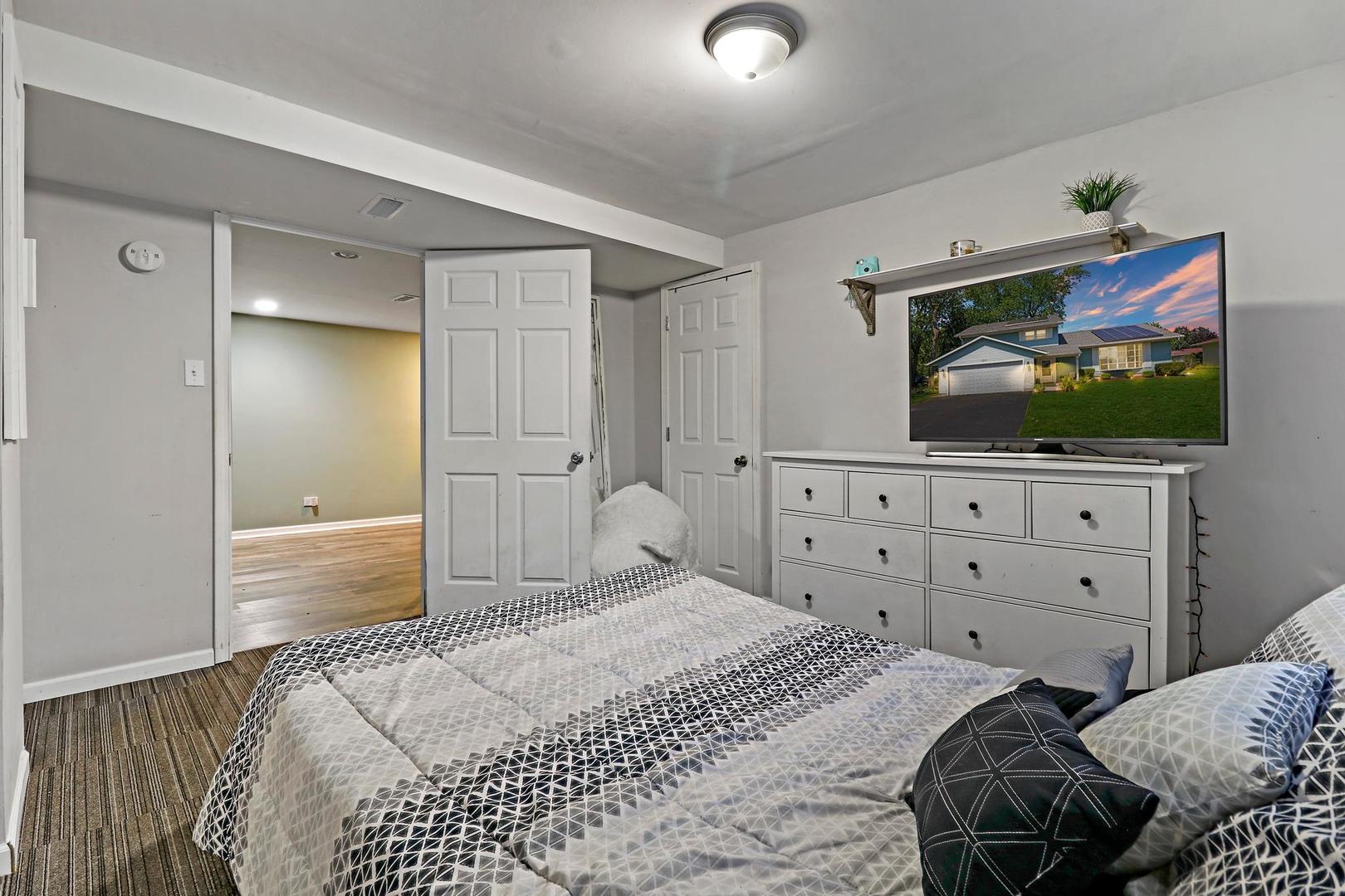 10254 West Beach Road Beach Park, IL 60099 - Photo 22 of 25 a bedroom with a bed and a flat screen tv in white dresser