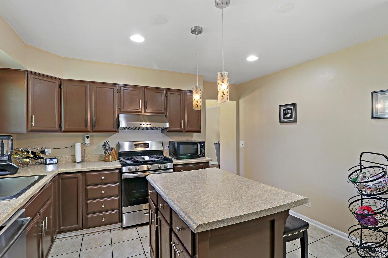 10254 West Beach Road Beach Park, IL 60099 - Photo 6 of 25 a kitchen with a sink a stove a refrigerator and cabinets