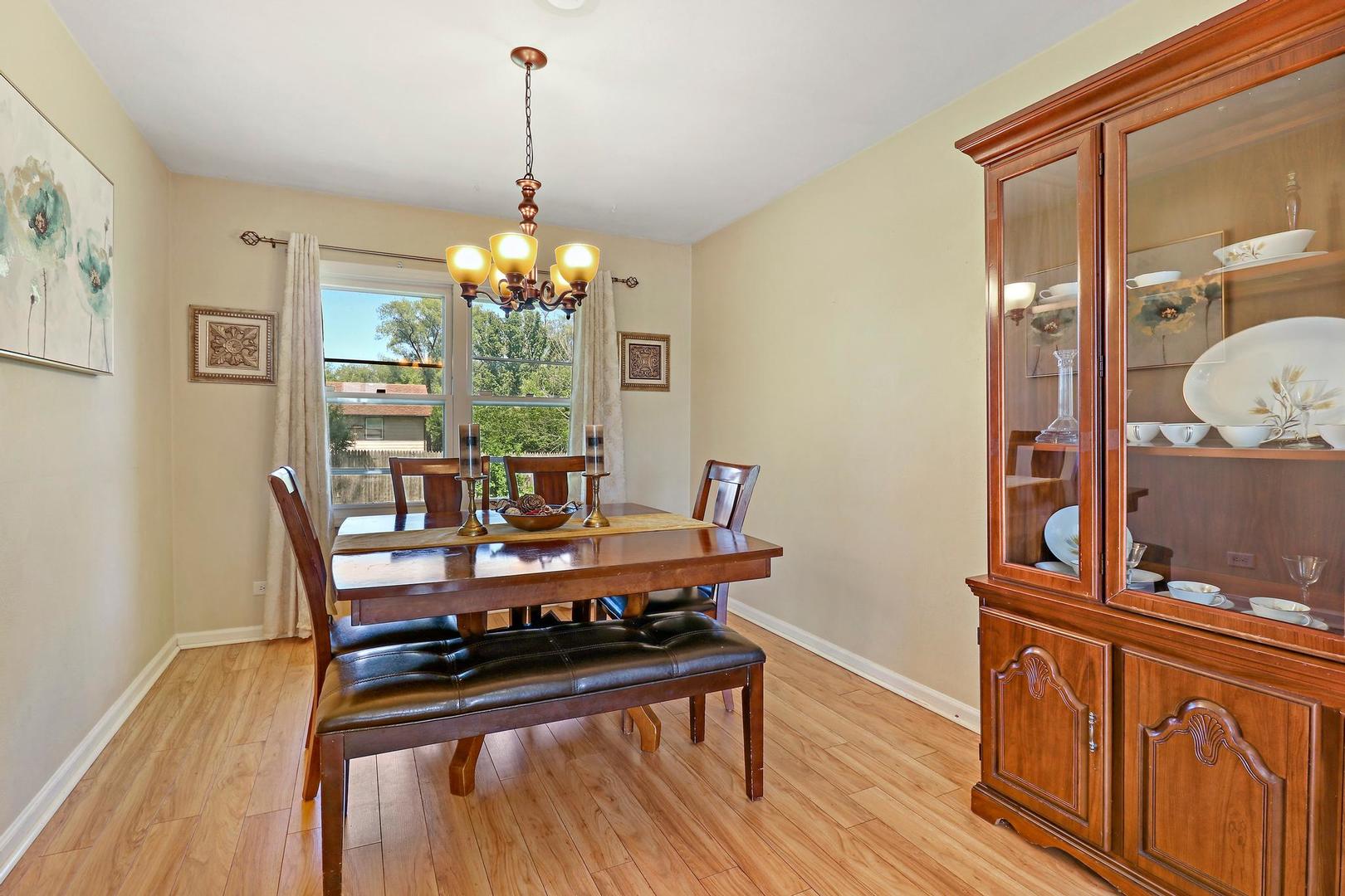 10254 West Beach Road Beach Park, IL 60099 - Photo 8 of 25 a view of a dining room with furniture and wooden floor