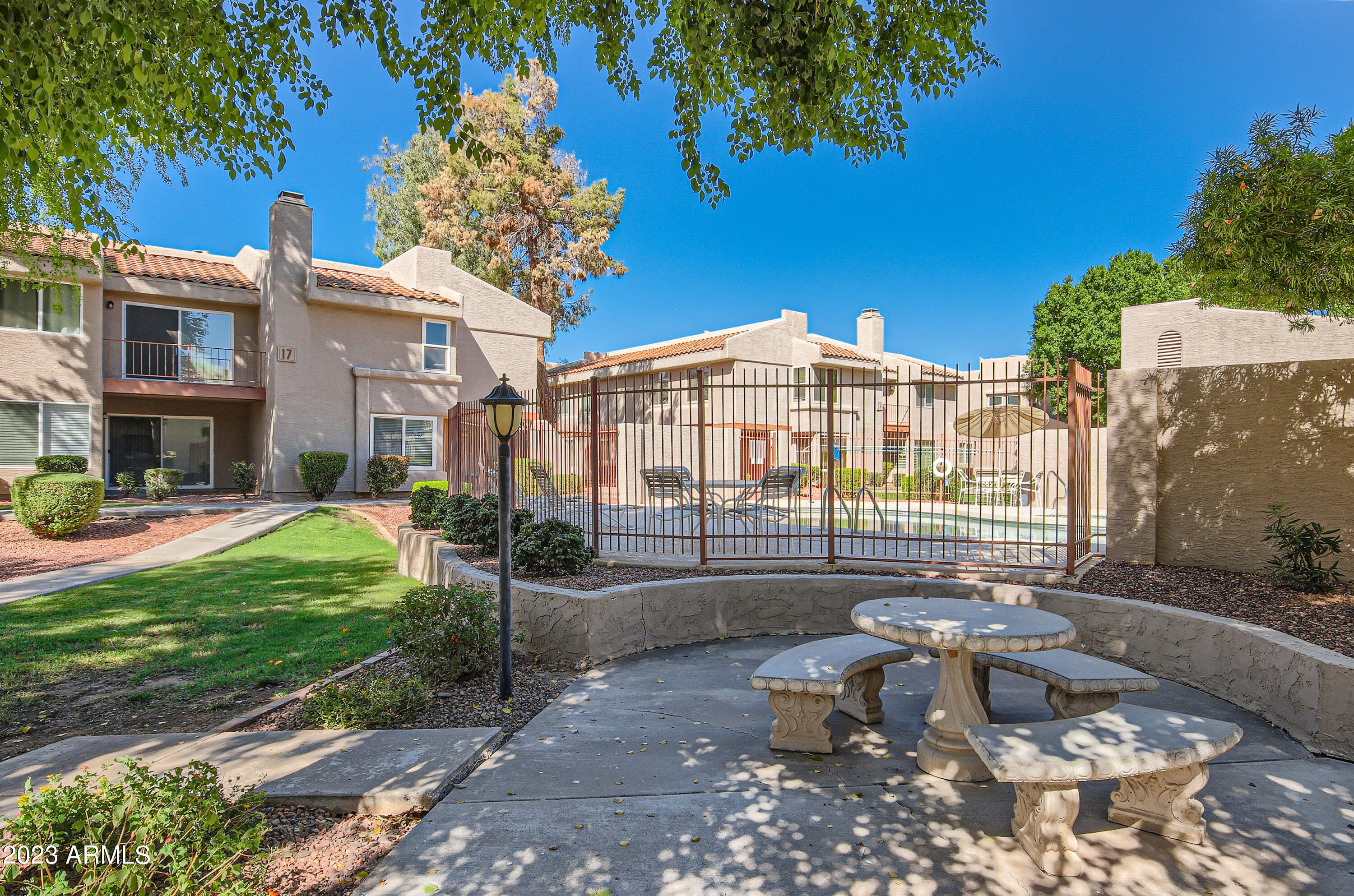 2834 South Ext Road, Unit 2093 Mesa, AZ 85210 - Photo 16 of 17 a view of a patio with table and chairs and potted plants