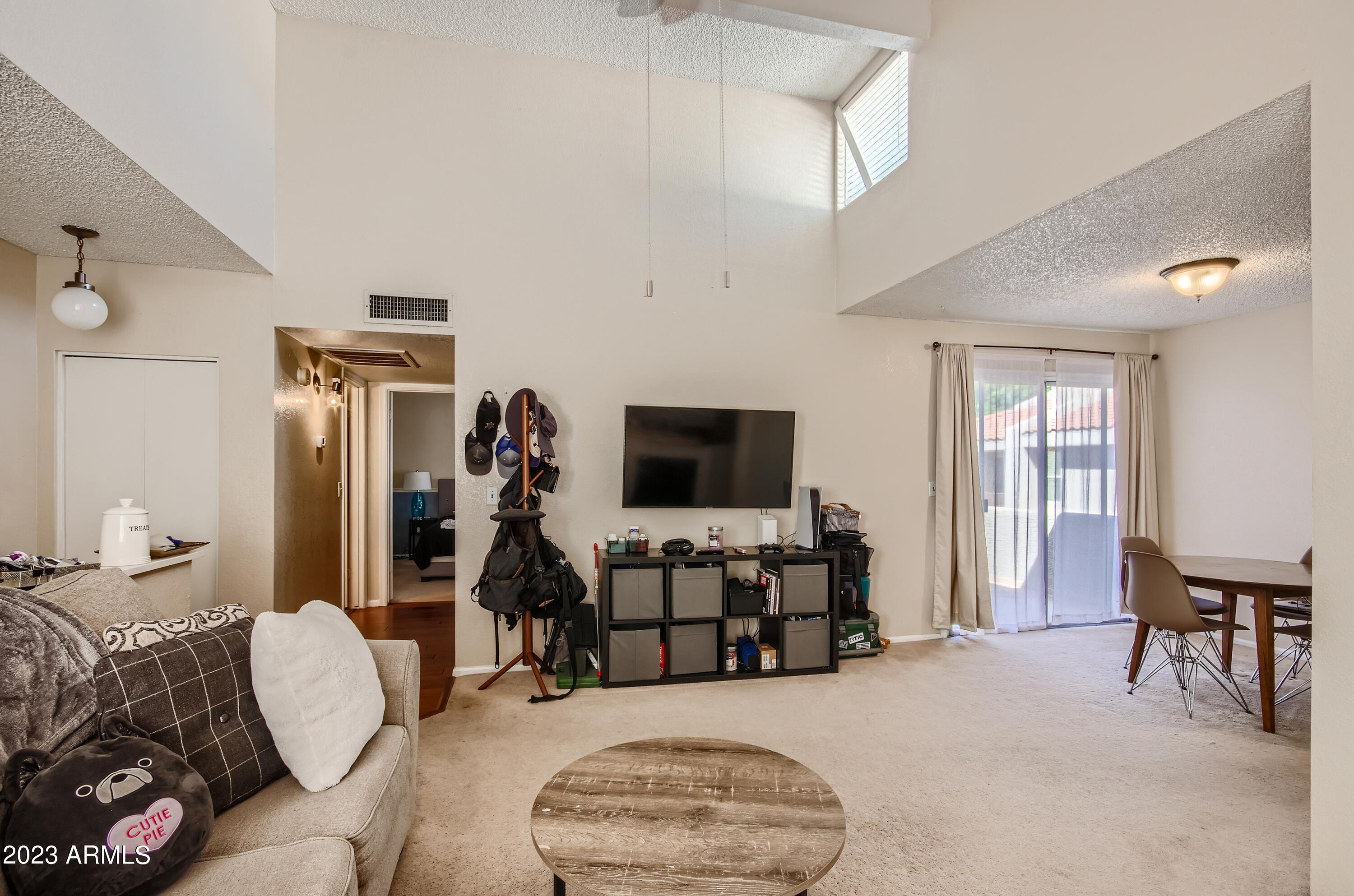 2834 South Ext Road, Unit 2093 Mesa, AZ 85210 - Photo 2 of 17 a living room with furniture and a flat screen tv