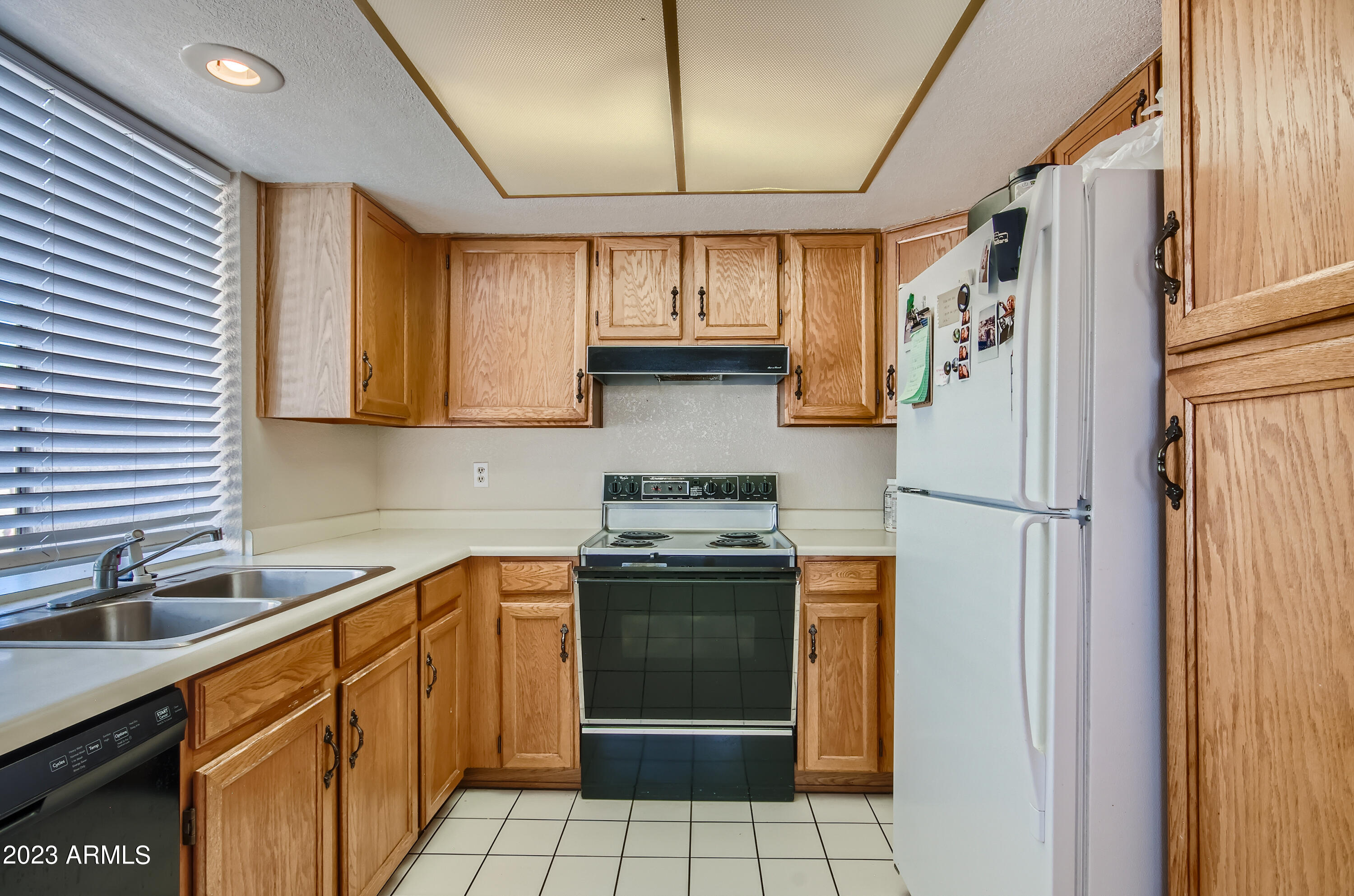 2834 South Ext Road, Unit 2093 Mesa, AZ 85210 - Photo 5 of 17 a kitchen with stainless steel appliances granite countertop a refrigerator and a sink