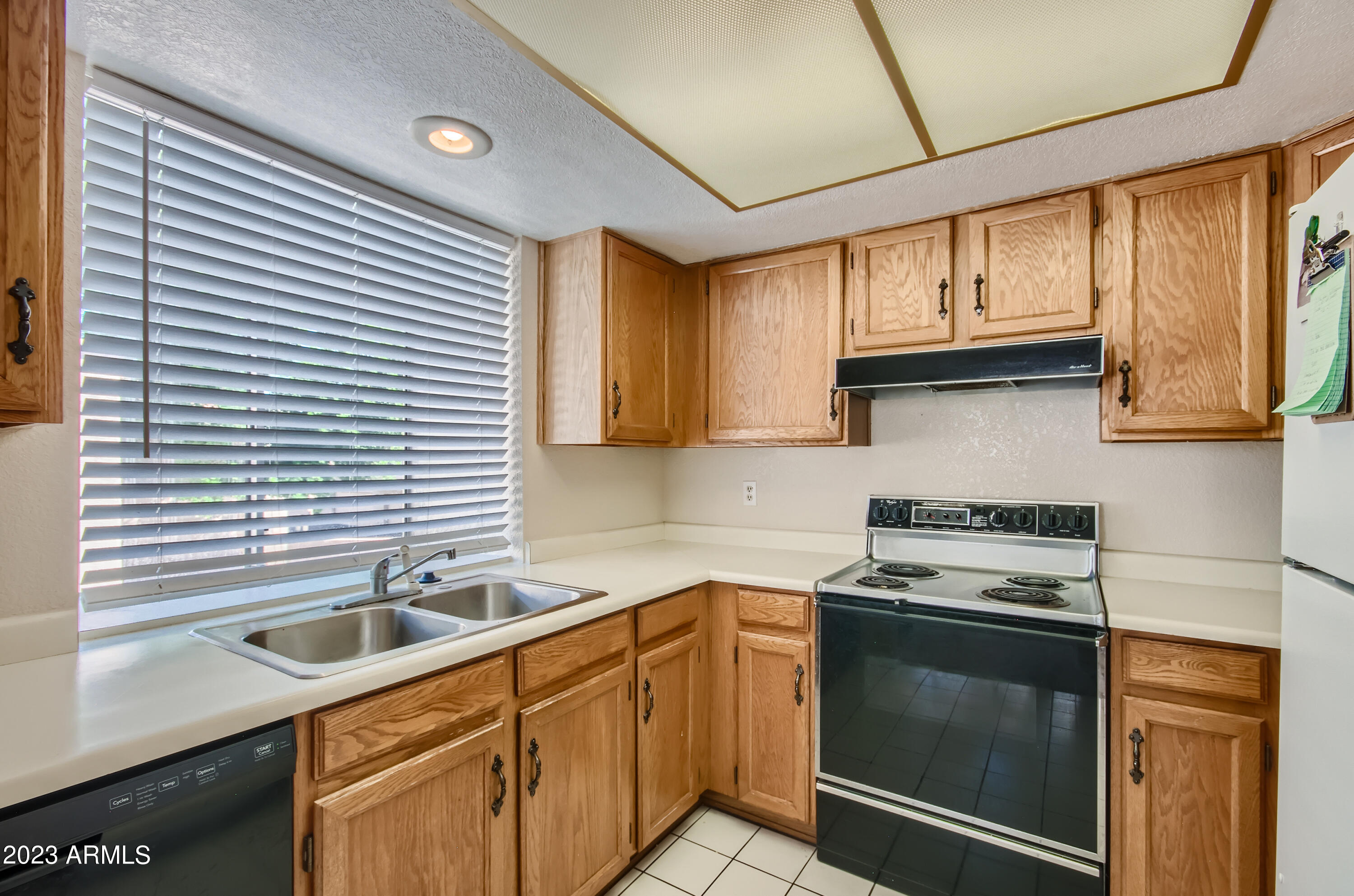 2834 South Ext Road, Unit 2093 Mesa, AZ 85210 - Photo 6 of 17 a kitchen with stainless steel appliances granite countertop a sink and a stove