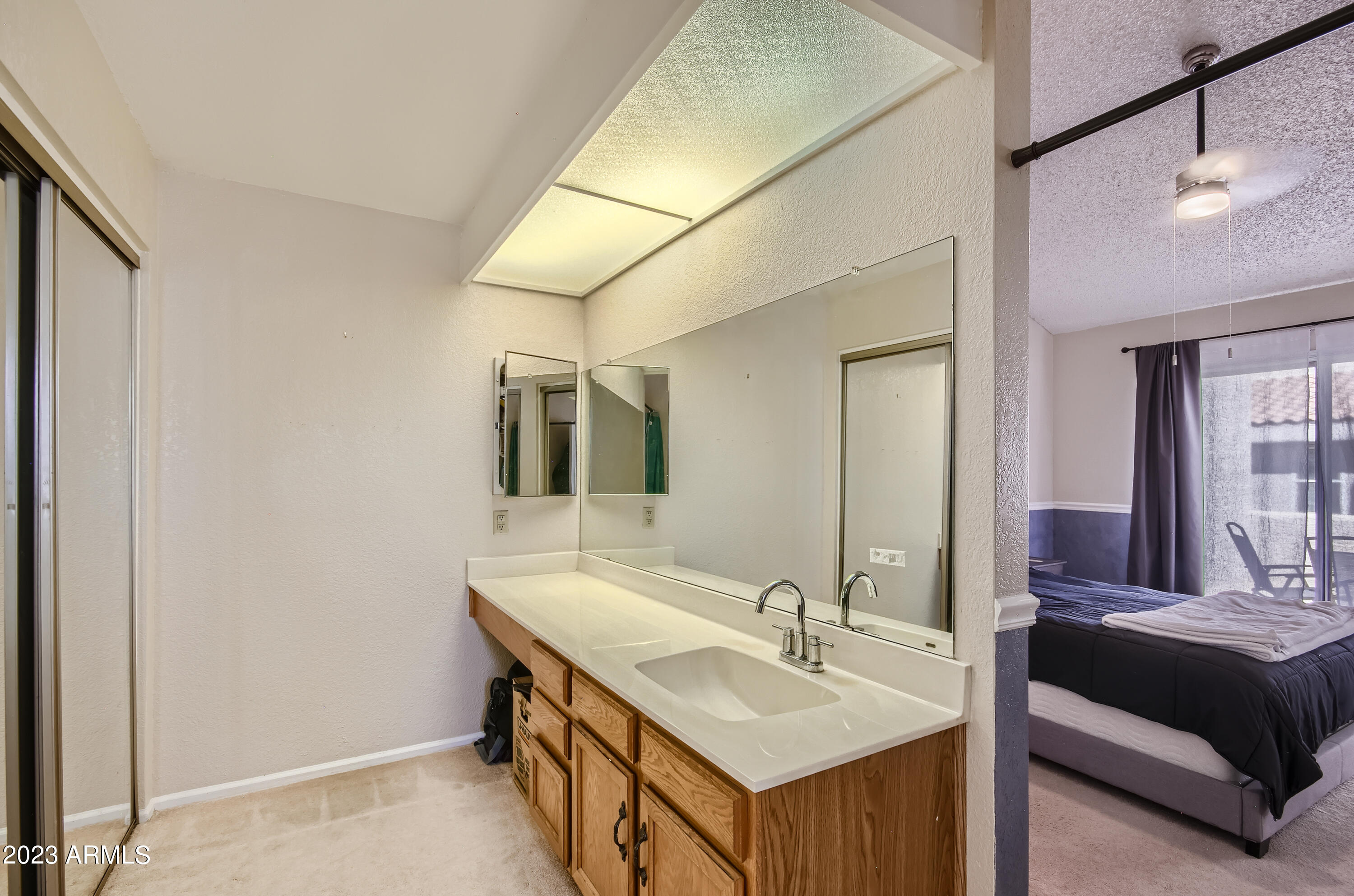 2834 South Ext Road, Unit 2093 Mesa, AZ 85210 - Photo 8 of 17 a en suite bathroom with a double vanity sink and a mirror