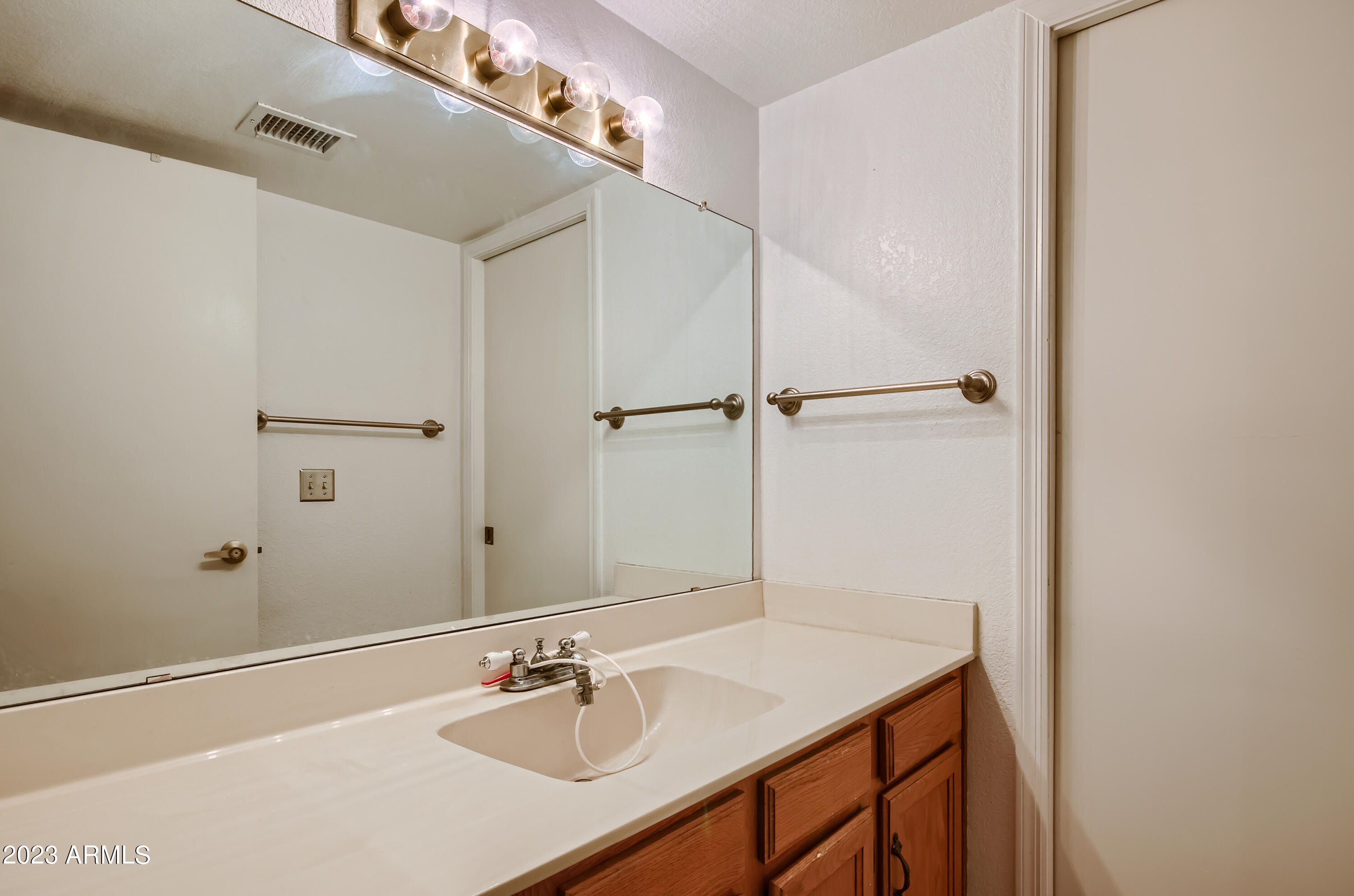 2834 South Ext Road, Unit 2093 Mesa, AZ 85210 - Photo 10 of 17 a bathroom with a sink and a mirror