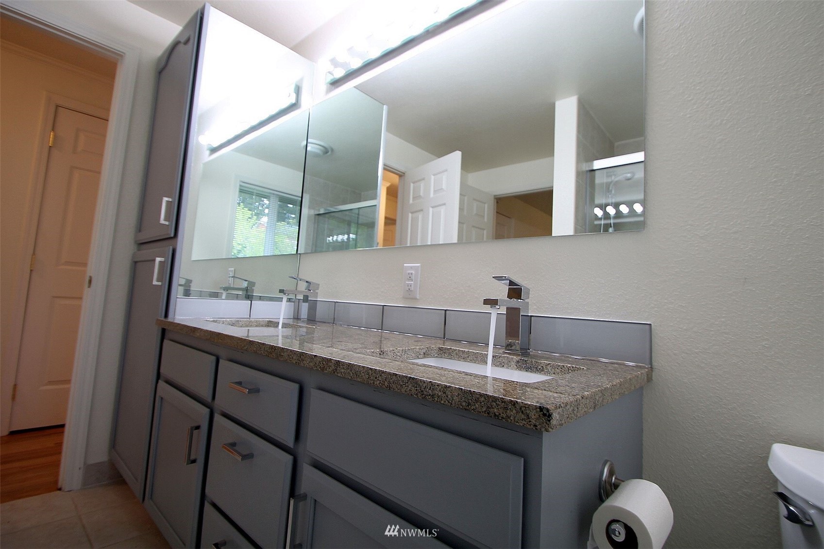 19504 Winesap Lane Bothell, WA 98012 - Photo 14 of 23 a bathroom with a granite countertop sink a toilet and mirror