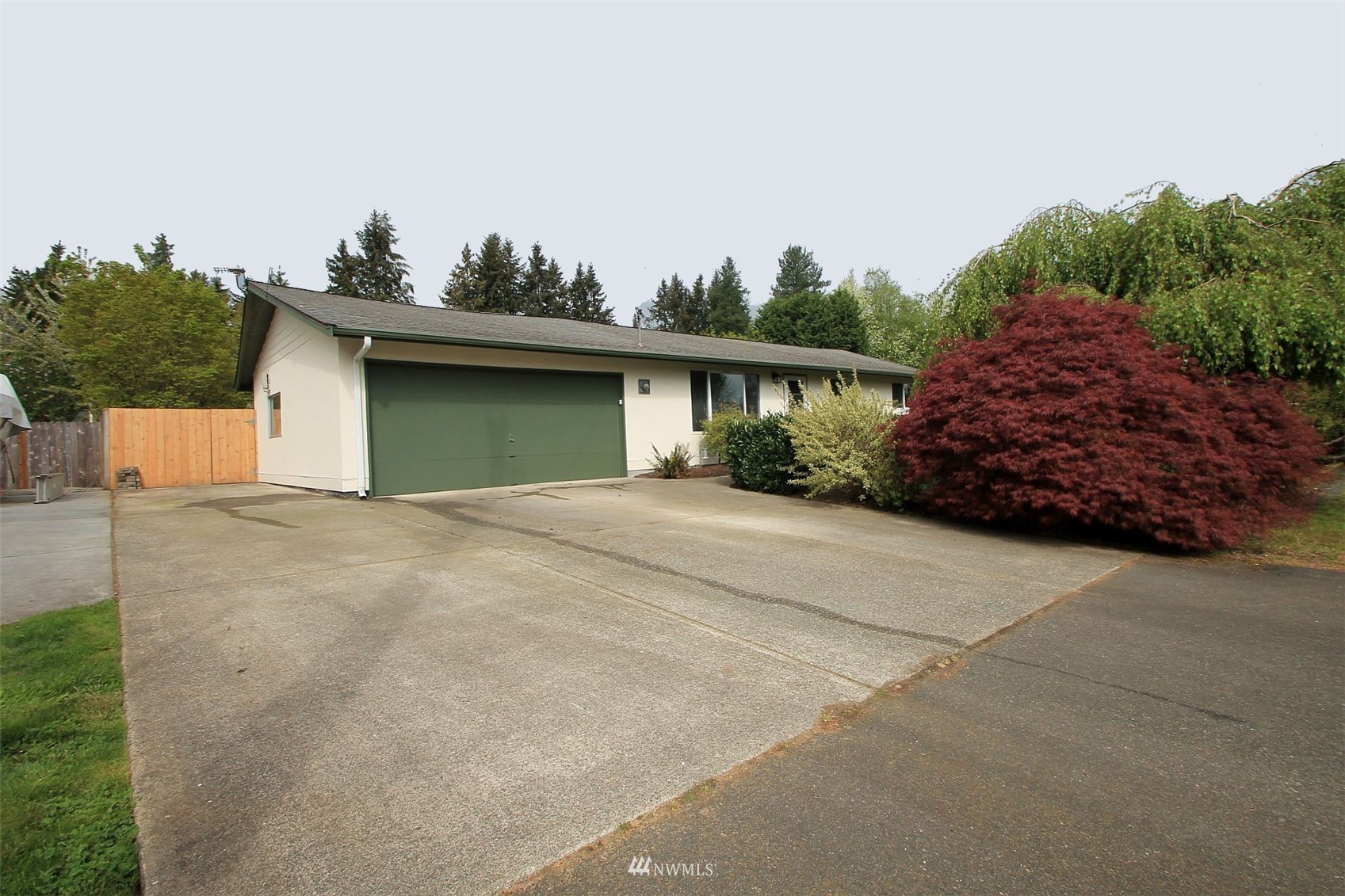 19504 Winesap Lane Bothell, WA 98012 - Photo 2 of 23 a front view of a house with a yard and garage