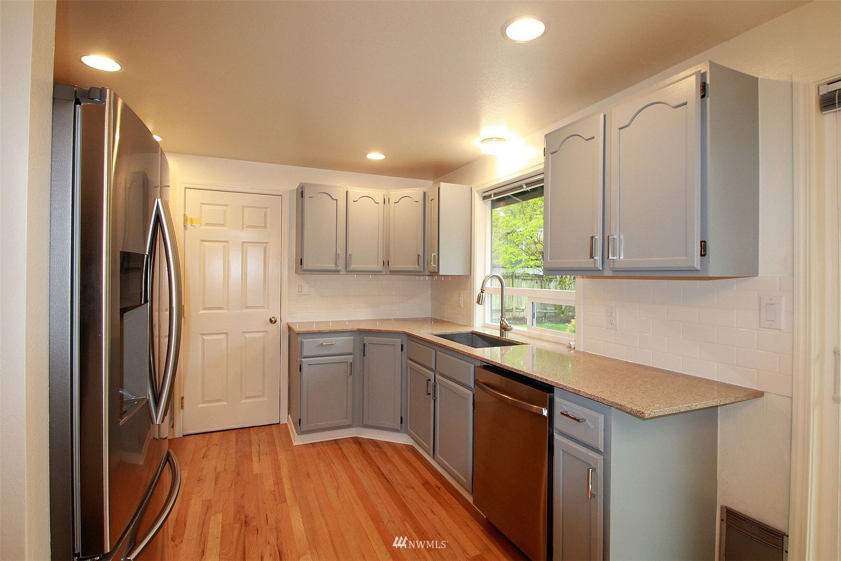 19504 Winesap Lane Bothell, WA 98012 - Photo 22 of 23 a kitchen with a refrigerator sink and cabinets