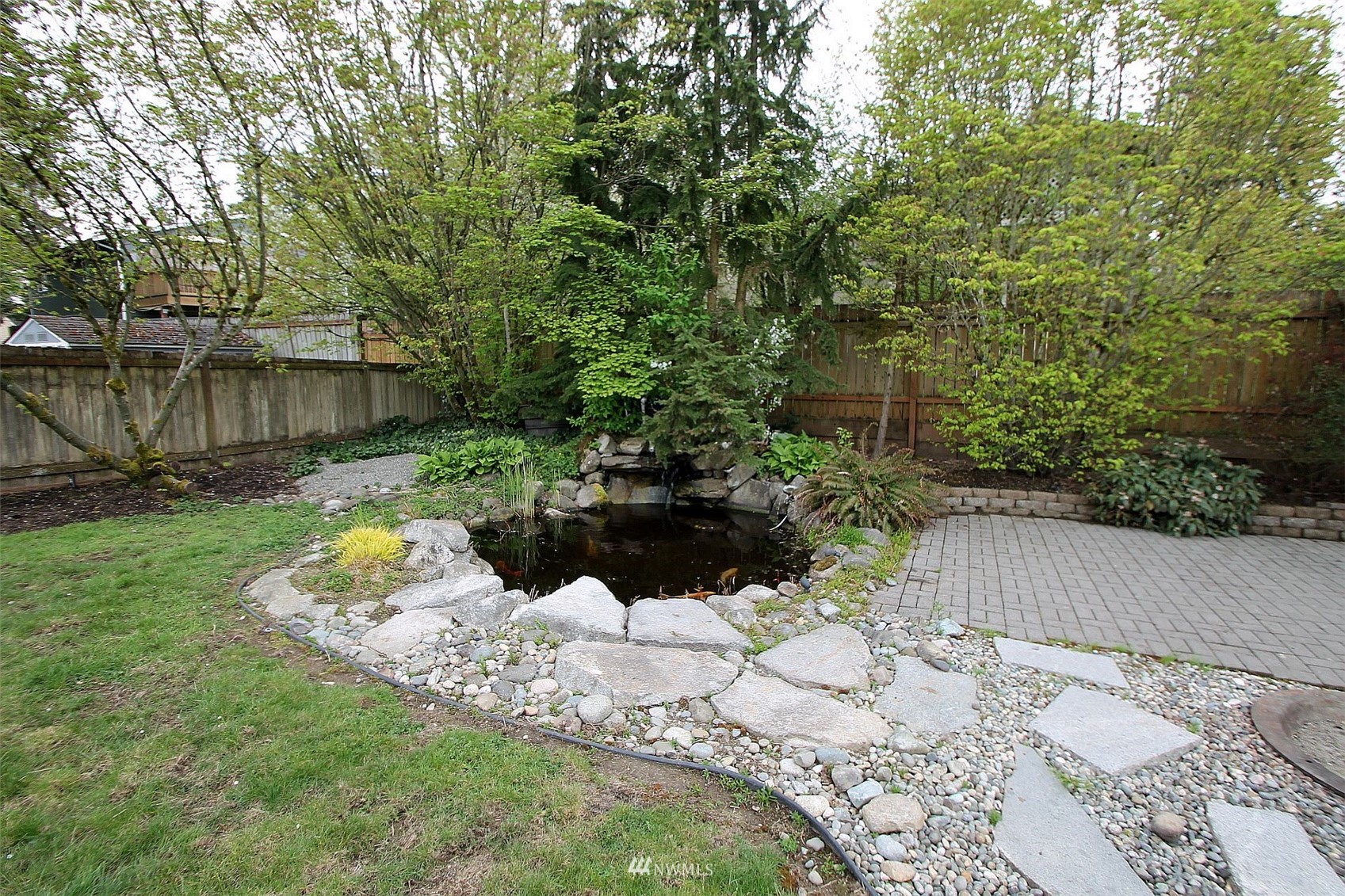 19504 Winesap Lane Bothell, WA 98012 - Photo 5 of 23 a wooden bench sitting in the middle of a yard