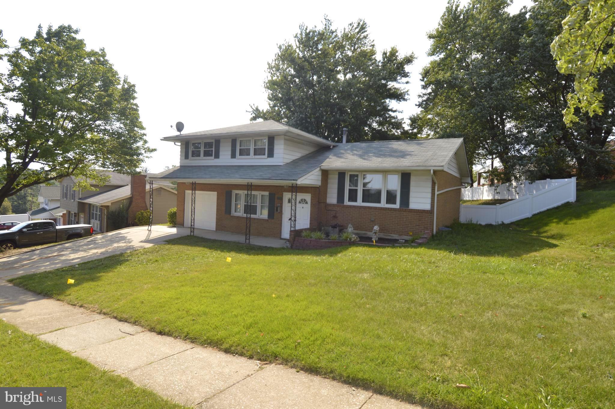 1730 Weyburn Road Baltimore, MD 21237 - Photo 2 of 25 a front view of a house with a yard table and chairs