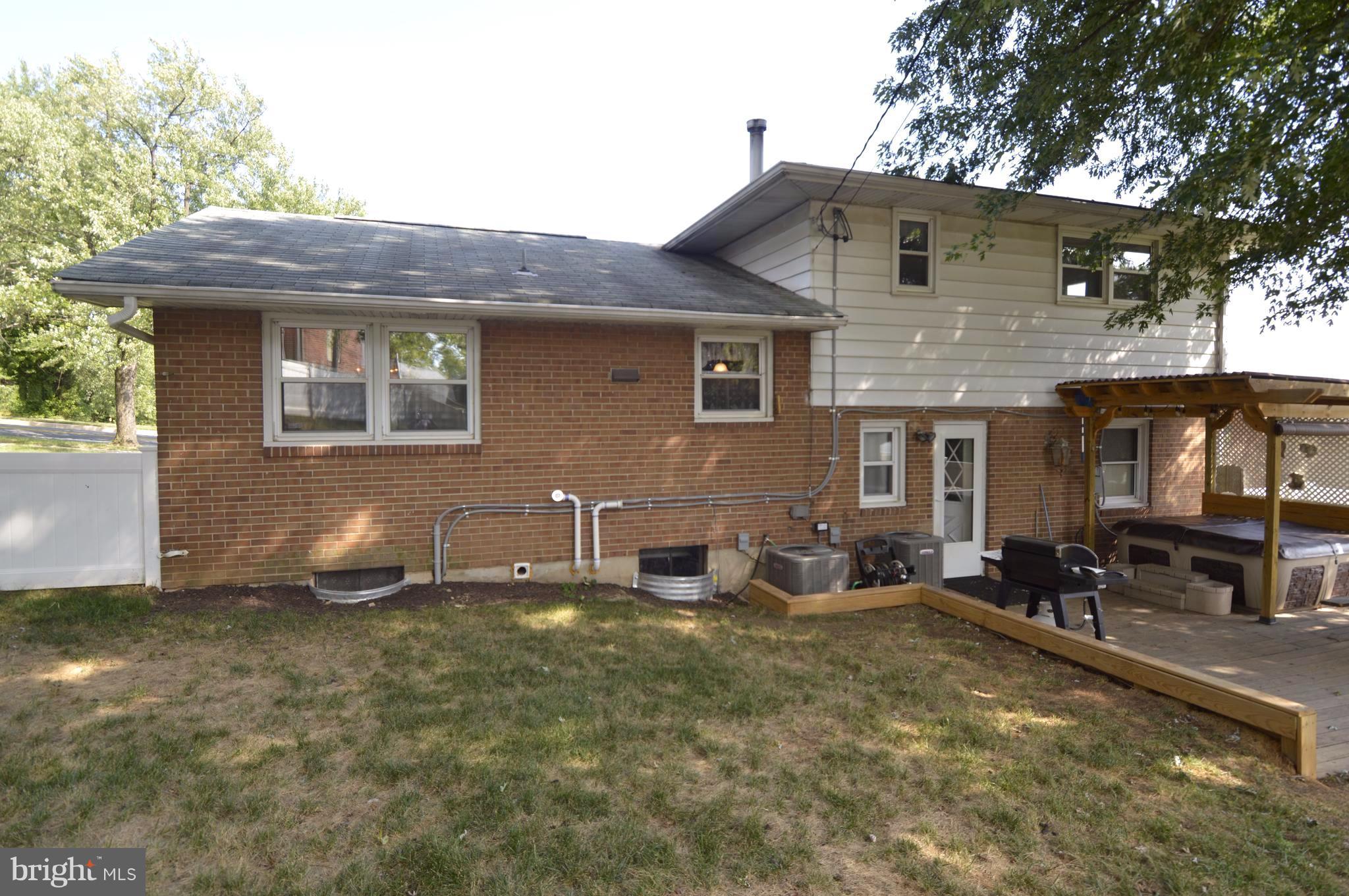 1730 Weyburn Road Baltimore, MD 21237 - Photo 19 of 25 a front view of house with yard outdoor seating and garage