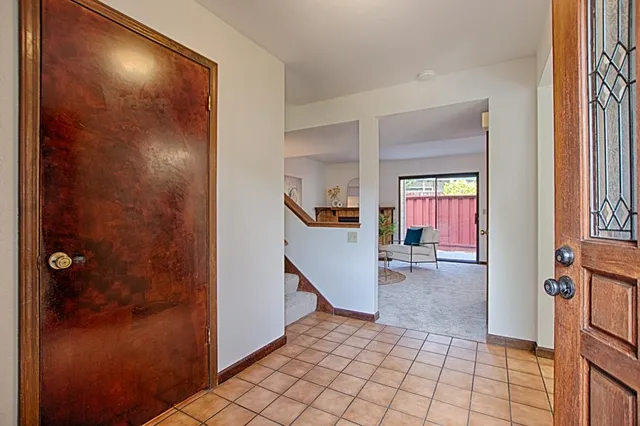 a view of a hallway to rooms and stairs