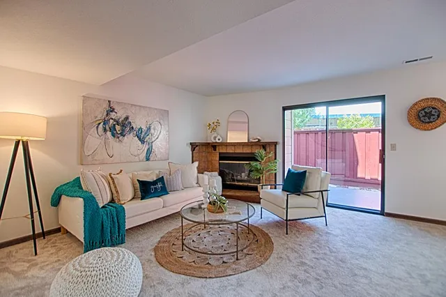 a living room with furniture a rug and a window