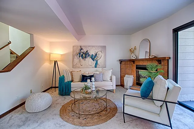 a living room with furniture and a fireplace