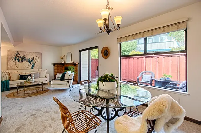 a living room with fireplace furniture and a chandelier